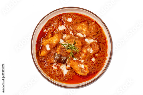 Top view of Panang pork curry with coconut milk and sliced kaffir lime leaves in a bowl isolated on white background, Panang curry is a very popular Thai dish.