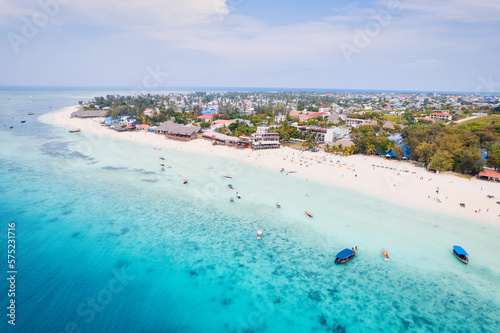 Fototapeta Naklejka Na Ścianę i Meble -  Spend your vacation in Zanzibar's picturesque Nungwi, where you can soak up the sun and admire the local fishing boats dotting the beach.