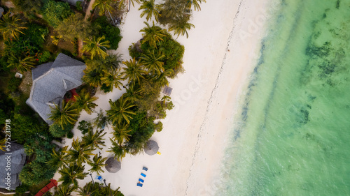 Indulge in a luxurious getaway at Zanzibar's Kiwengwa beach, where the white sand, turquoise waters, and palm trees create a serene and refreshing atmosphere for a truly memorable vacation.