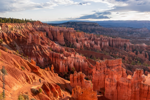 Aerial scenic morning sunrise view of hoodoo sandstone rock formations on Navajo Rim hiking trail in Bryce Canyon National Park, Utah, USA. Golden hour colored natural amphitheatre in barren landscape