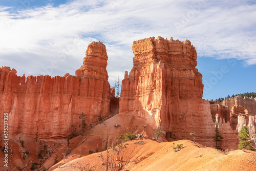Scenic view of massive hoodoo sandstone rock formation towers on Queens Garden trail in Bryce Canyon National Park, Utah, USA. Barren desert landscape in natural amphitheatre on sunny summer day