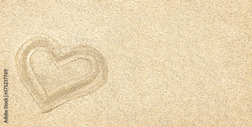 Sand. Texture, surface of sea sand. A heart drawn in the sand. Natural background. Close-up. View from above. Smooth. Space for text. Copy space