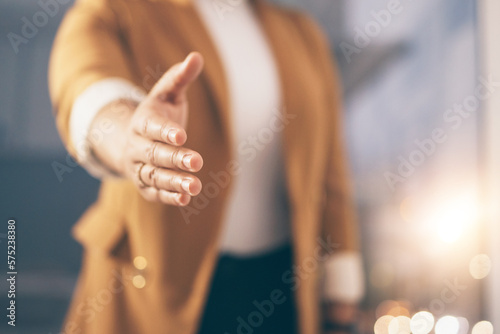 Business woman stretching her hand for a shaking hands for greeting  welcome or partnership in office. Company  corporate and female employee with handshake gesture for agreement in modern workplace.