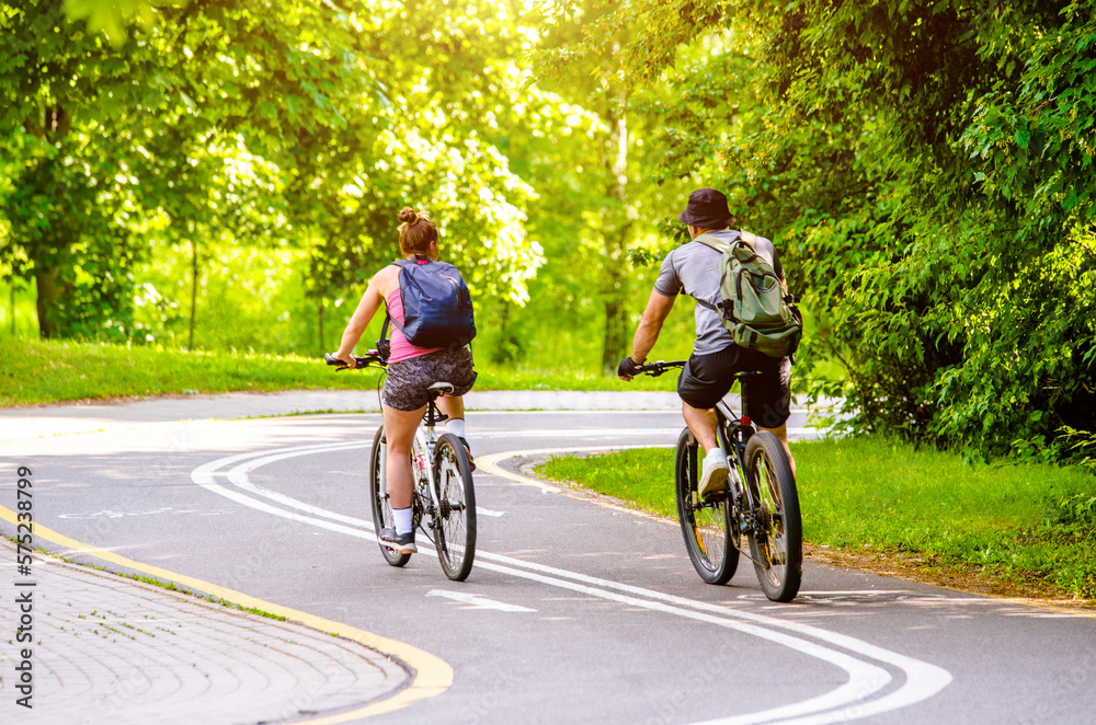 Cyclists ride on the bike path in the city Park
