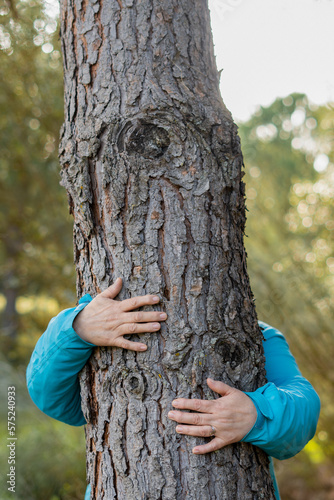 woman hugging a tree in the forest
