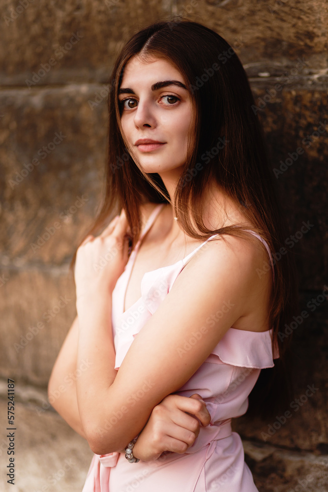 Naklejka premium portrait of a beautiful young woman with big eyes in a pink dress