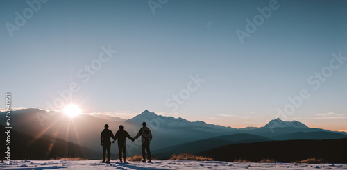 Silhouette of two person on top of mountain peak. / Holding Hands / coaching goal, success and teamwork concepts - Mountains Mountaineer / Space for Text / Blank Space / Copy Text