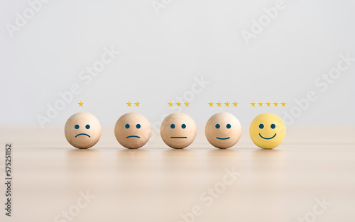 the happy face smile face icon on a wooden cube for Customer service evaluation customer satisfaction level and satisfaction survey concepts.