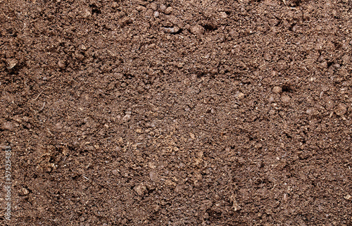 Abstract background. The surface of black fertile land for agriculture with the addition of peat