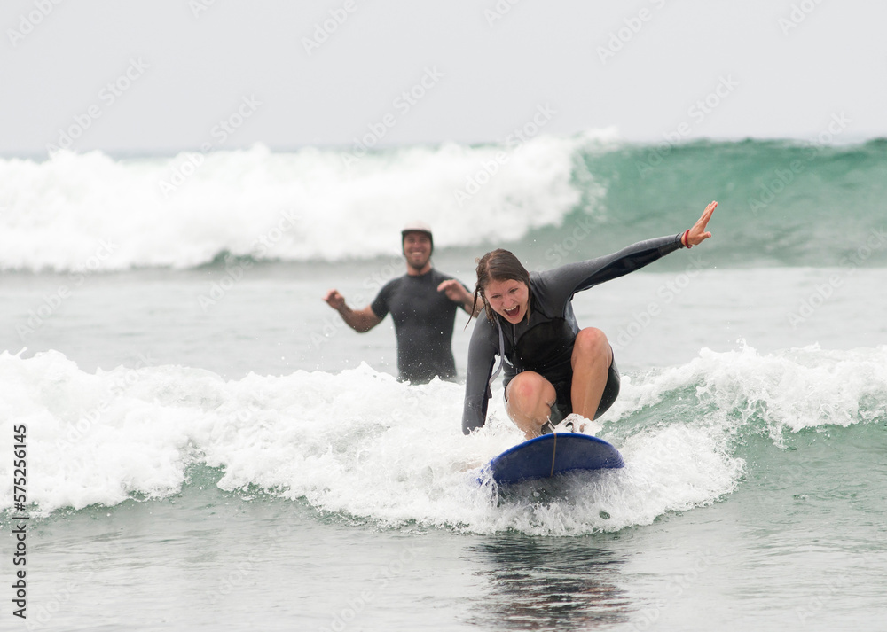 A woman learns to surf with her boyfriend. A woman learns to surf with her boyfriend.