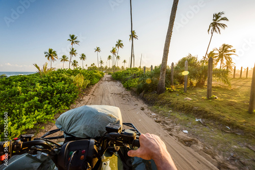 View from quad motorcycle in tropical scenery with palm trees, Taipu de Fora beach, South Bahia, Barra Grande, Brazil photo