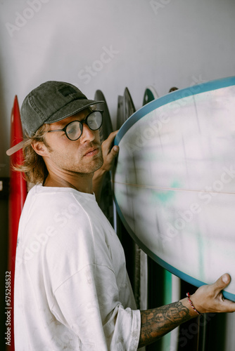 Man choosing a surfboard in a surfboard shop