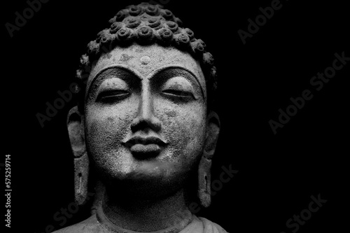 Buddha Face Statue Isolated On Black Background, Granite Buddha Statue Portrait.