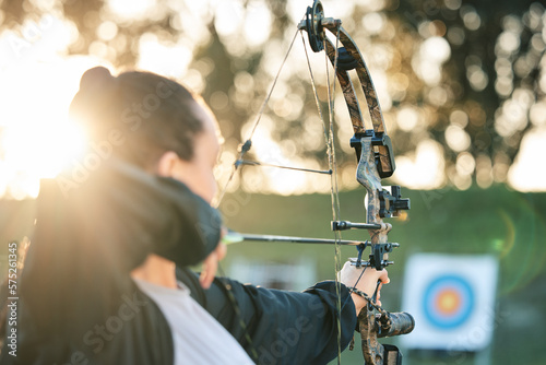 Archer woman, target and bow and arrow practice for outdoor archery, athlete challenge or girl field competition. Shooting goals, talent and competitive focus on precision training, aim or objective