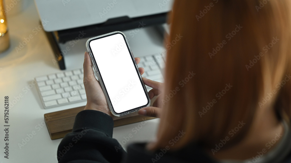 Woman holding smart phone with white blank display, empty screen for graphic display montage