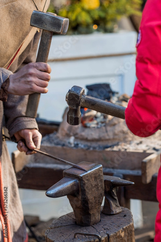 Moscow seasons. Traditional craft. The work of a blacksmith with metal at the celebration of Maslenitsa. Master class for children and adults. Russian traditions. Tverskaya Street. Moscow. Russia
