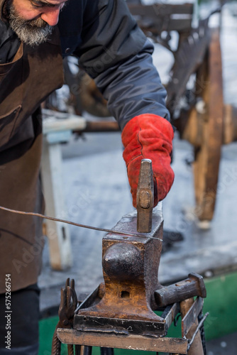 Moscow seasons. Traditional craft. The work of a blacksmith with metal at the celebration of Maslenitsa (Maslenitsa Week). Russian traditions. Tverskaya Street. Moscow. Russia