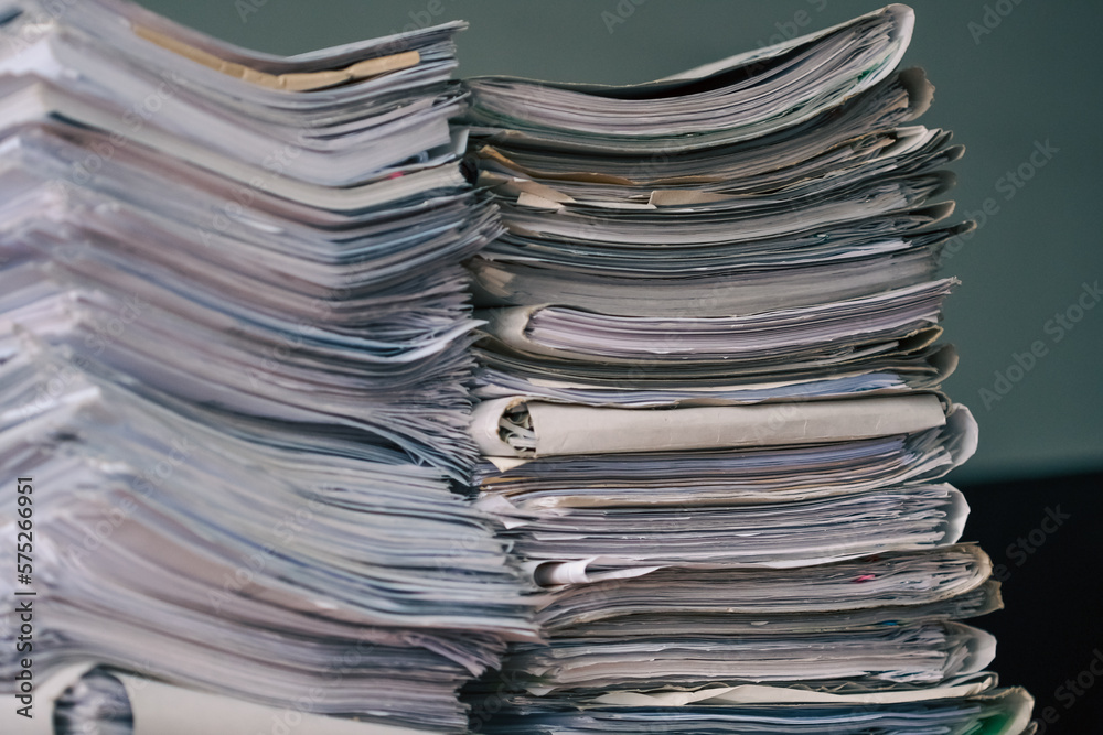 Stack of blank papers with binder clips on wooden table indoors. Workplace. Many documents, contracts, legal agreements, papers on work table. Concept of business, working, job. Stack of blank papers with binder clips on wooden table indoors. Workplace. Many documents, contracts, legal agreements, papers on work table. Concept of business, working, job.