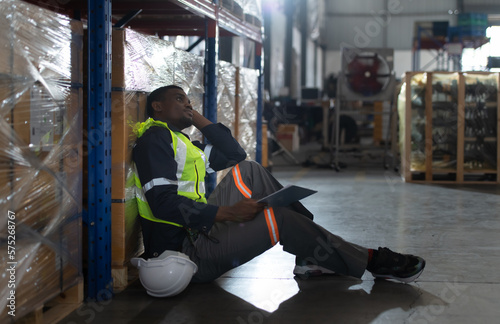 Head of worker in an auto parts warehouse, Sit back and relax after examine auto parts that are ready to be shipped to the automobile assembly factory.