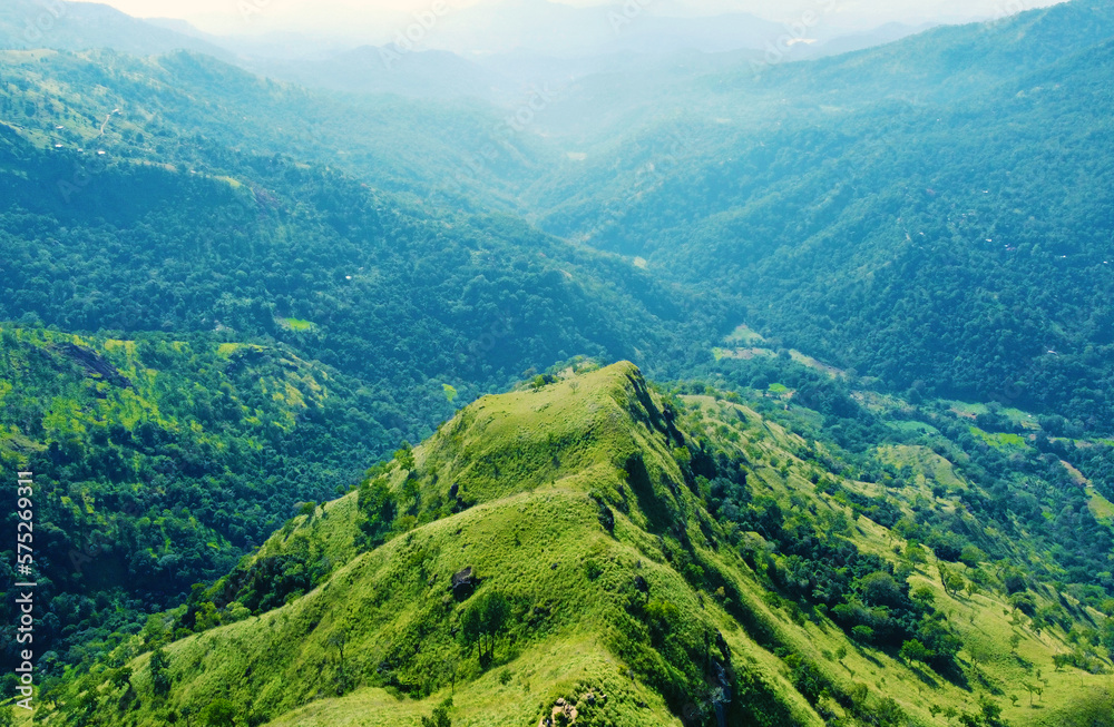 Aerial view of the green hills and gorge. Beautiful mountain background texture for tourism and advertising. Tropical landscape from a drone Aerial view of the green hills and gorge. Beautiful mountain background texture for tourism and advertising. Tropical landscape from a drone