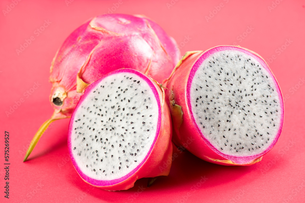 Dragon fruit, Pitahaya, Pitaya exotic asian vegan juicy fruits close up. Over pink background. Dragon fruit, Pitahaya, Pitaya exotic asian vegan juicy fruits close up. Over pink background.