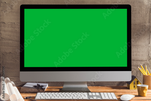 Chroma key green screen computer on table with architectural equipment