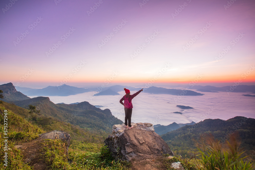 Young woman in red jacket hiking on the high mountain, Phu Chee Duean, border of Thailand and Laos. Young woman in red jacket hiking on the high mountain, Phu Chee Duean, border of Thailand and Laos.