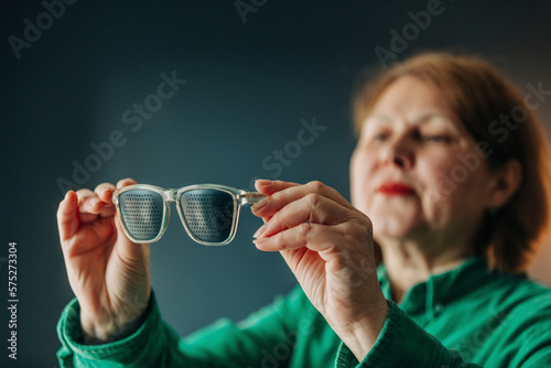 elderly woman wearing special glasses for eye training