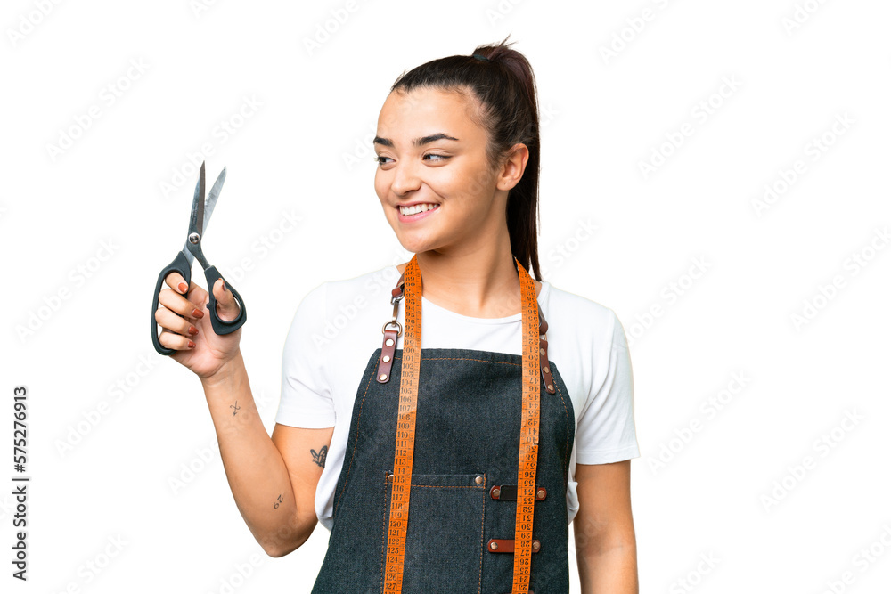 Seamstress woman over isolated chroma key background looking side Seamstress woman over isolated chroma key background looking side