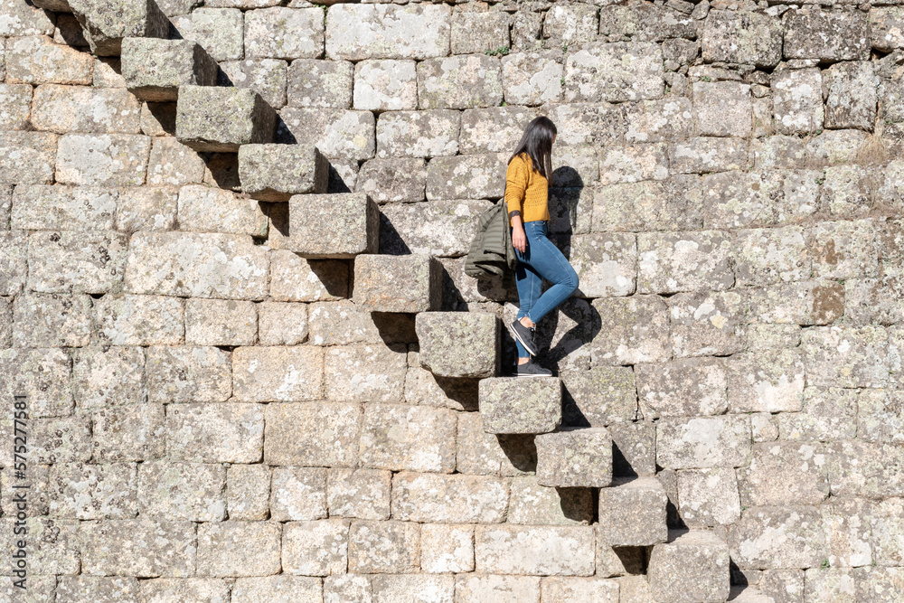 Young girl going down the old stairs of the castle of Monsanto medieval village, Portugal Young girl going down the old stairs of the castle of Monsanto medieval village, Portugal