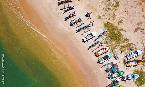 Aerial view of colorful fishing boats on the ocean. Beautiful Asian texture background for tourism and advertising. Tropical landscape from a drone