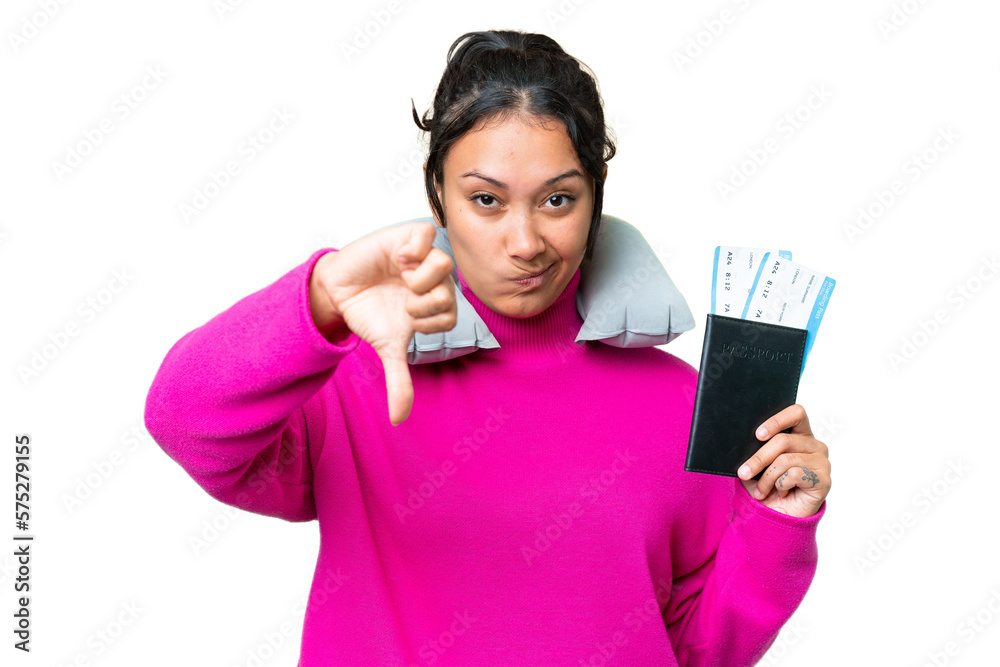Young Uruguayan woman holding a passport over isolated chroma key background showing thumb down with negative expression Young Uruguayan woman holding a passport over isolated chroma key background showing thumb down with negative expression