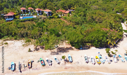 Aerial view of colorful fishing boats on the ocean. Beautiful Asian texture background for tourism and advertising. Tropical landscape from a drone