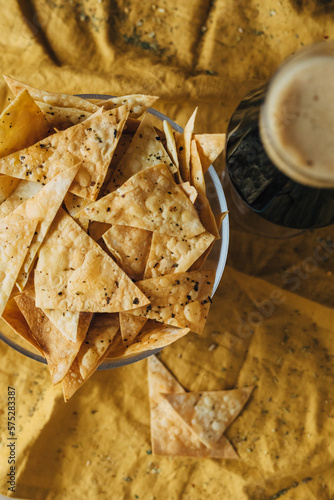 Beer and beer snacks, chips, nachos with seasoning.