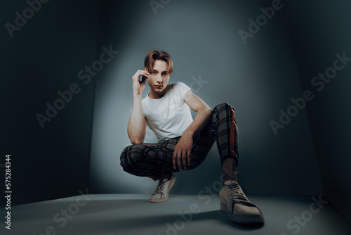 Obraz na plátně fisheye portrait of young man with 90s look and hairstyle look at camera with ha