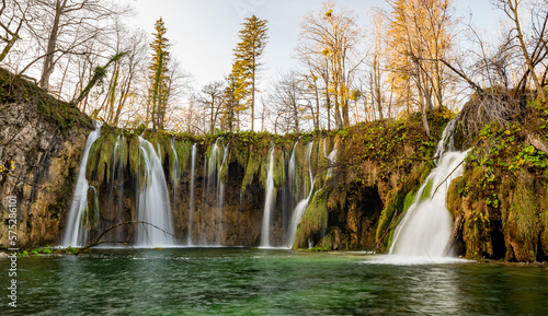 Plitvice Lakes National Park during colorful autumn, Croatia, Europe. Fall colors leafs on trees. Waterfalls and water in sunny morning light with fog. Landscape photography. View of Plitvicka Jezera.