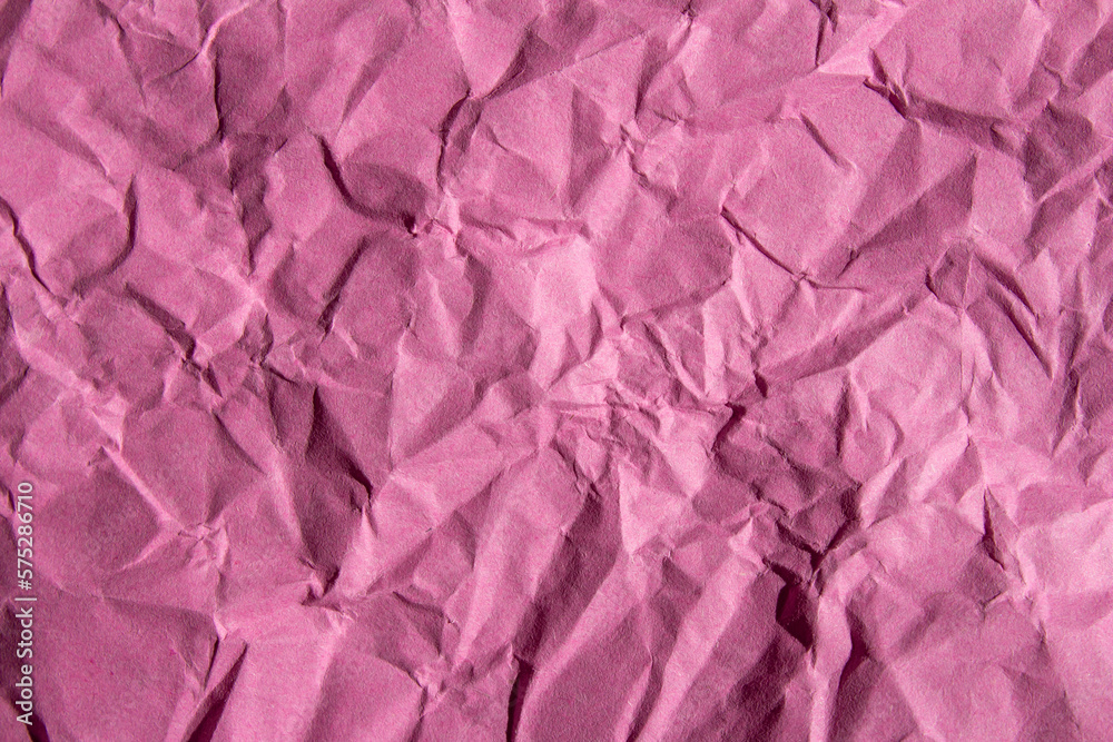 Crumpled pink paper texture background. Wrinkled paper surface for designs. Crumpled pink paper texture background. Wrinkled paper surface for designs.