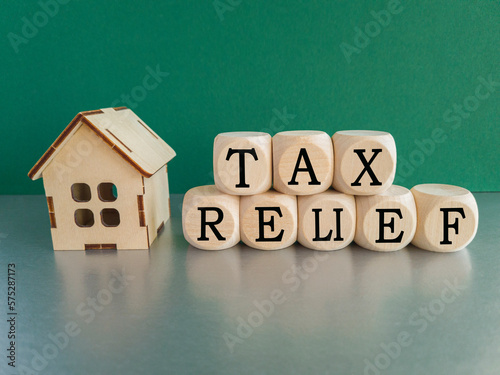 Tax relief symbol. Concept words 'tax relief' on wooden blocks on a beautiful green background. Business and tax relief concept.