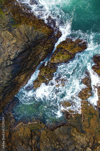 Aerial view of the sea rocks cliffs in the ocean. Beautiful sea wallpaper for tourism and advertising. Stormy landscape, drone photo