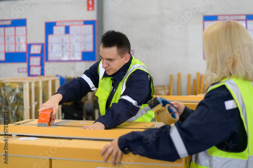 Group of worker in auto parts warehouse Packing small parts in boxes after inspecting the car parts that are ready to be sent to the car assembly plant.