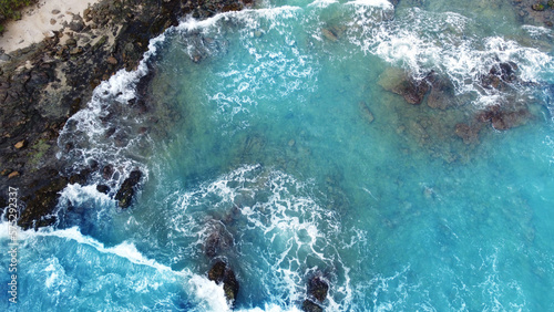 Aerial view of the sea rocks cliffs in the ocean. Beautiful sea wallpaper for tourism and advertising. Stormy landscape, drone photo