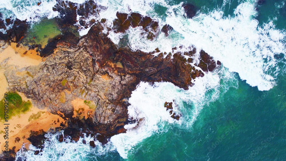 Obraz premium Aerial view of the sea rocks cliffs in the ocean. Beautiful sea wallpaper for tourism and advertising. Stormy landscape, drone photo