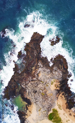Aerial view of the sea rocks cliffs in the ocean. Beautiful sea wallpaper for tourism and advertising. Stormy landscape, drone photo