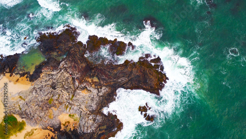 Aerial view of the sea rocks cliffs in the ocean. Beautiful sea wallpaper for tourism and advertising. Stormy landscape, drone photo