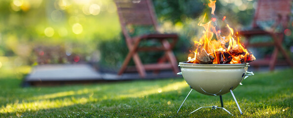 Barbecue grill with bright fire on open air. Camping