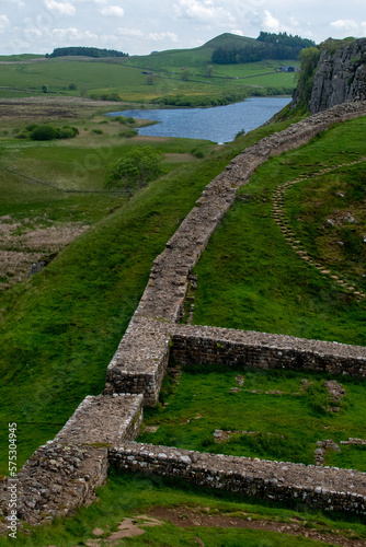 A section of Hadrian's Wall at Roman military base Milecastle 39, against the backdrop of Whin Sill and Crag Lough. Northumberland National Park, UK