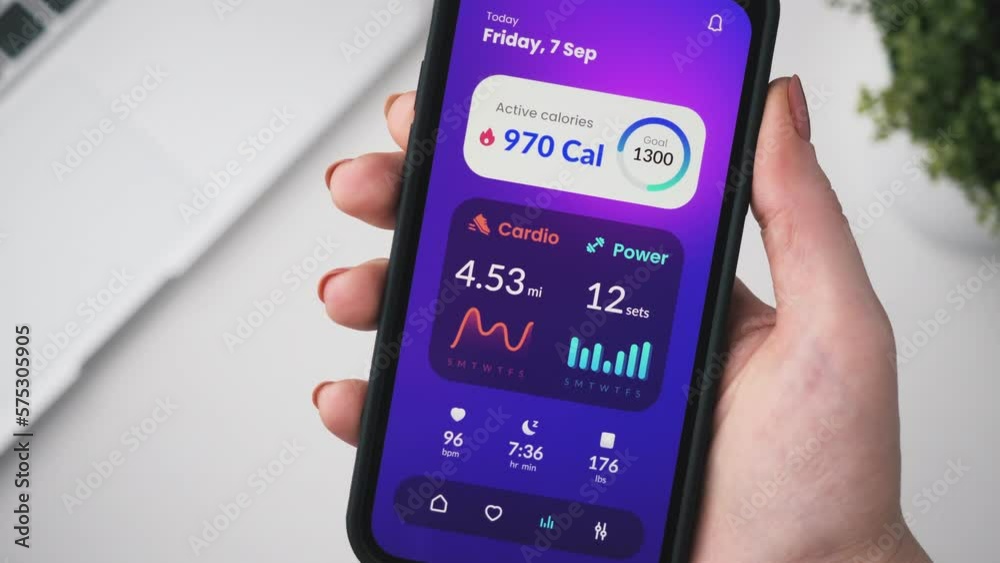 Woman tracking her fitness data. Checking fitness goals and looking at workout statistics using app for mobile phone.