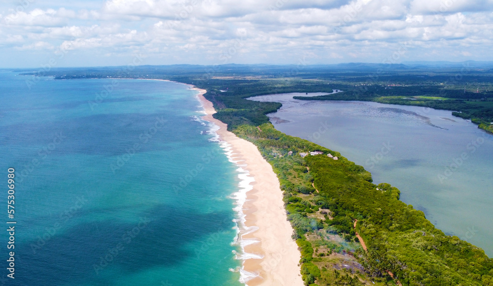 Aerial view of the long sandy tropical ocean shore. Beautiful tropical wallpapers for tourism and advertising. Asian landscape, drone photo Aerial view of the long sandy tropical ocean shore. Beautiful tropical wallpapers for tourism and advertising. Asian landscape, drone photo