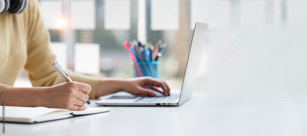 Fototapeta premium Asian student sitting with laptop, studying online in library at university, studying online, online web education concept.