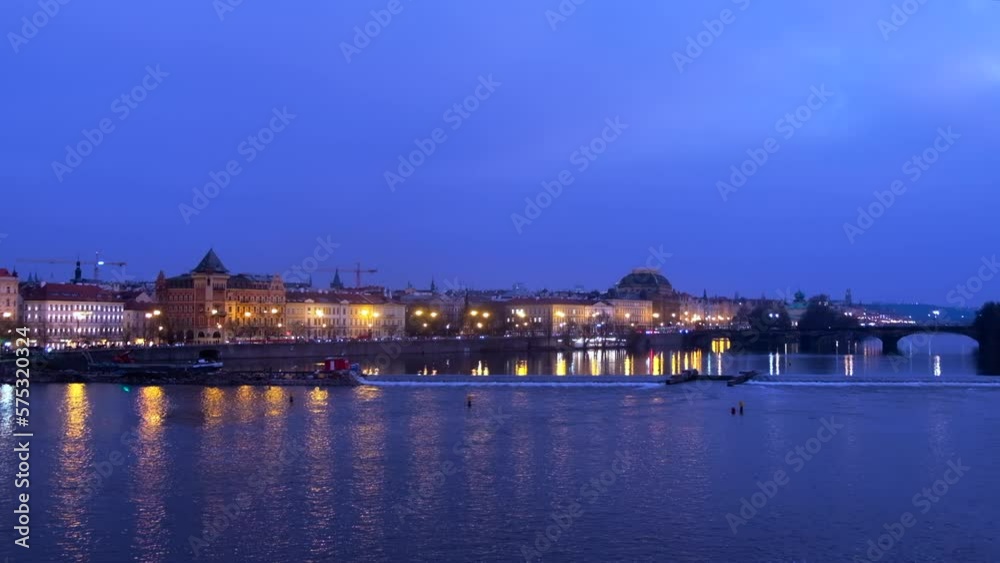 Vltava River and city with buildings, boats on river, Czech Republic Vltava River and city with buildings, boats on river, Czech Republic